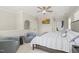 Comfortable carpeted bedroom with chair seating area, ceiling fan, and wall-mounted TV at 8524 Society Pl, Raleigh, NC 27615