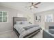 Light and airy bedroom featuring a queen bed, ceiling fan, and an abundance of natural light at 8524 Society Pl, Raleigh, NC 27615