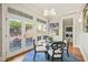 Charming dining area with backyard access, a glass table, and a view into the laundry room at 8524 Society Pl, Raleigh, NC 27615