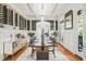 Formal dining room with hardwood floors, coffered ceilings, wine storage and seating for eight at 8524 Society Pl, Raleigh, NC 27615