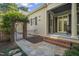 Beautiful home exterior with brick and stone pathway, lush landscaping, and an iron gate entrance at 8524 Society Pl, Raleigh, NC 27615
