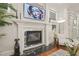 Elegant fireplace detail with mantel, modern art, and decorative items enhancing the room's ambiance at 8524 Society Pl, Raleigh, NC 27615