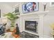 Close-up of an elegant fireplace with a decorative mantel, mirrored accents, and modern artwork above at 8524 Society Pl, Raleigh, NC 27615