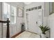 Bright foyer with elegant wainscoting, decorative mirror, and marble-potted plant at 8524 Society Pl, Raleigh, NC 27615
