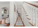 Bright hallway featuring hardwood floors, staircase and arched doorways to other rooms at 8524 Society Pl, Raleigh, NC 27615