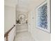 Upper hallway with decorative mirror, modern art, and neutral color palette creating an airy space at 8524 Society Pl, Raleigh, NC 27615
