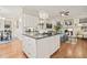Open-concept kitchen with hardwood floors, chandelier, flows seamlessly into the living room at 8524 Society Pl, Raleigh, NC 27615