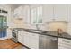 Elegant kitchen features stainless appliances, black countertops, and a window for natural light at 8524 Society Pl, Raleigh, NC 27615