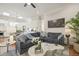 Inviting living room with stylish sofa, marble-topped tables, open layout, and access to the kitchen at 8524 Society Pl, Raleigh, NC 27615