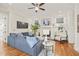 Spacious living room features hardwood floors, a large sofa, elegant decor, and a decorative fireplace at 8524 Society Pl, Raleigh, NC 27615