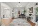 Sophisticated living room with piano, statement art, modern light fixture, and French doors at 8524 Society Pl, Raleigh, NC 27615