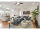 Open-concept living area showcasing a comfortable sofa, hardwood flooring, and modern decor throughout at 8524 Society Pl, Raleigh, NC 27615