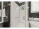 Modern all-white shower with a glass door, window, and chrome fixtures providing a luxurious bathroom experience at 8524 Society Pl, Raleigh, NC 27615