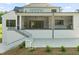 Inviting covered patio with an outdoor fireplace and fan at 9004 Meadow Pointe Ct, Wake Forest, NC 27587