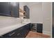 Stylish bar featuring dark blue cabinetry, wooden shelves, and beverage fridge at 9004 Meadow Pointe Ct, Wake Forest, NC 27587