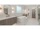 Bright primary bathroom with double vanities, soaker tub, gold fixtures, and a glass shower at 9004 Meadow Pointe Ct, Wake Forest, NC 27587