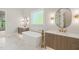 Elegant bathroom featuring double vanities, soaking tub, marble floors, and stylish gold fixtures at 9004 Meadow Pointe Ct, Wake Forest, NC 27587