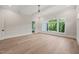 Bright, spacious bedroom with hardwood floors, large windows, and access to outdoor living at 9004 Meadow Pointe Ct, Wake Forest, NC 27587