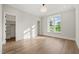 Bright bedroom with hardwood floors, large window, and ample closet space, perfect for relaxation and storage at 9004 Meadow Pointe Ct, Wake Forest, NC 27587