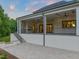 Spacious covered porch with a stone patio offers an ideal setting for relaxation and outdoor entertainment at 9004 Meadow Pointe Ct, Wake Forest, NC 27587