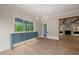 Elegant dining area featuring hardwood floors, chandelier, and custom blue cabinetry at 9004 Meadow Pointe Ct, Wake Forest, NC 27587