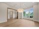 Bright dining area with hardwood floors, large windows, and decorative chandelier at 9004 Meadow Pointe Ct, Wake Forest, NC 27587