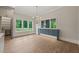 Bright dining area featuring hardwood floors, chandelier, and custom cabinetry at 9004 Meadow Pointe Ct, Wake Forest, NC 27587