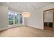 Dining room with hardwood floors, large window, and decorative chandelier at 9004 Meadow Pointe Ct, Wake Forest, NC 27587