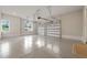 Bright garage with epoxy flooring, two white garage doors, and a side window at 9004 Meadow Pointe Ct, Wake Forest, NC 27587