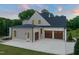 Spacious three-car garage with carriage doors and ample driveway space at 9004 Meadow Pointe Ct, Wake Forest, NC 27587