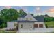 Three car garage with dark wood doors and exterior lighting at 9004 Meadow Pointe Ct, Wake Forest, NC 27587