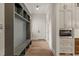 Hallway with gray built-ins, a bench, coat hooks, and hardwood floors for a stylish and organized transition space at 9004 Meadow Pointe Ct, Wake Forest, NC 27587
