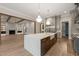 Spacious kitchen with stainless steel appliances, a gas range, and a large center island with quartz countertop at 9004 Meadow Pointe Ct, Wake Forest, NC 27587