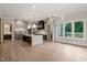 Large kitchen with an island, hardwood floors, stainless steel refrigerator and plenty of cabinet space at 9004 Meadow Pointe Ct, Wake Forest, NC 27587
