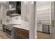 Modern kitchen featuring stainless steel appliances, range hood, and custom cabinets at 9004 Meadow Pointe Ct, Wake Forest, NC 27587
