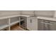 Kitchenette featuring modern cabinetry, wine fridge, stainless dishwasher and open shelving at 9004 Meadow Pointe Ct, Wake Forest, NC 27587