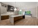 Open concept kitchen featuring a black range hood, stainless appliances and a large island at 9004 Meadow Pointe Ct, Wake Forest, NC 27587