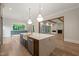 Beautiful kitchen island with a built-in sink, stainless steel appliances and access to the living room at 9004 Meadow Pointe Ct, Wake Forest, NC 27587