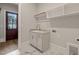 Well-lit laundry room with a built-in sink, storage cabinets, and dark herringbone floors at 9004 Meadow Pointe Ct, Wake Forest, NC 27587