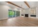 Bright living room with wood beam ceiling, fireplace, built-in shelving, and sliding glass doors to the outdoor patio at 9004 Meadow Pointe Ct, Wake Forest, NC 27587