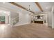 Expansive open floor plan showcasing light hardwood flooring, staircase, a modern kitchen, and seamless flow throughout the living space at 9004 Meadow Pointe Ct, Wake Forest, NC 27587