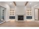 Living room featuring a modern fireplace with built-in shelves, exposed wood beams, and sliding glass doors to a patio at 9004 Meadow Pointe Ct, Wake Forest, NC 27587
