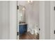 Stylish powder room with a blue vanity cabinet, gold fixtures, and a modern mirror at 9004 Meadow Pointe Ct, Wake Forest, NC 27587