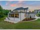 Expansive rear exterior of a home with a covered porch, patio, and manicured landscaping at 9004 Meadow Pointe Ct, Wake Forest, NC 27587