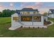 Beautiful home exterior with a covered porch, patio, and stairs leading to the manicured backyard at 9004 Meadow Pointe Ct, Wake Forest, NC 27587