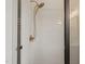 Shower detail with gold fixtures and white tiled walls, showcasing a spa-like experience at 9004 Meadow Pointe Ct, Wake Forest, NC 27587