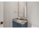 Close-up on the stylish vanity, highlighting the countertop, gold fixtures, blue cabinet, and mirror at 9004 Meadow Pointe Ct, Wake Forest, NC 27587