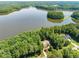 Scenic aerial shot of a lakeside property with mature trees and a view of the water at 901 Edgewater Dr, Garner, NC 27529