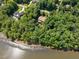 Lakefront home nestled among trees, offering a serene waterfront lifestyle at 901 Edgewater Dr, Garner, NC 27529