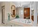 Elegant bathroom featuring a soaking tub with decorative columns and detailed woodwork throughout at 901 Edgewater Dr, Garner, NC 27529